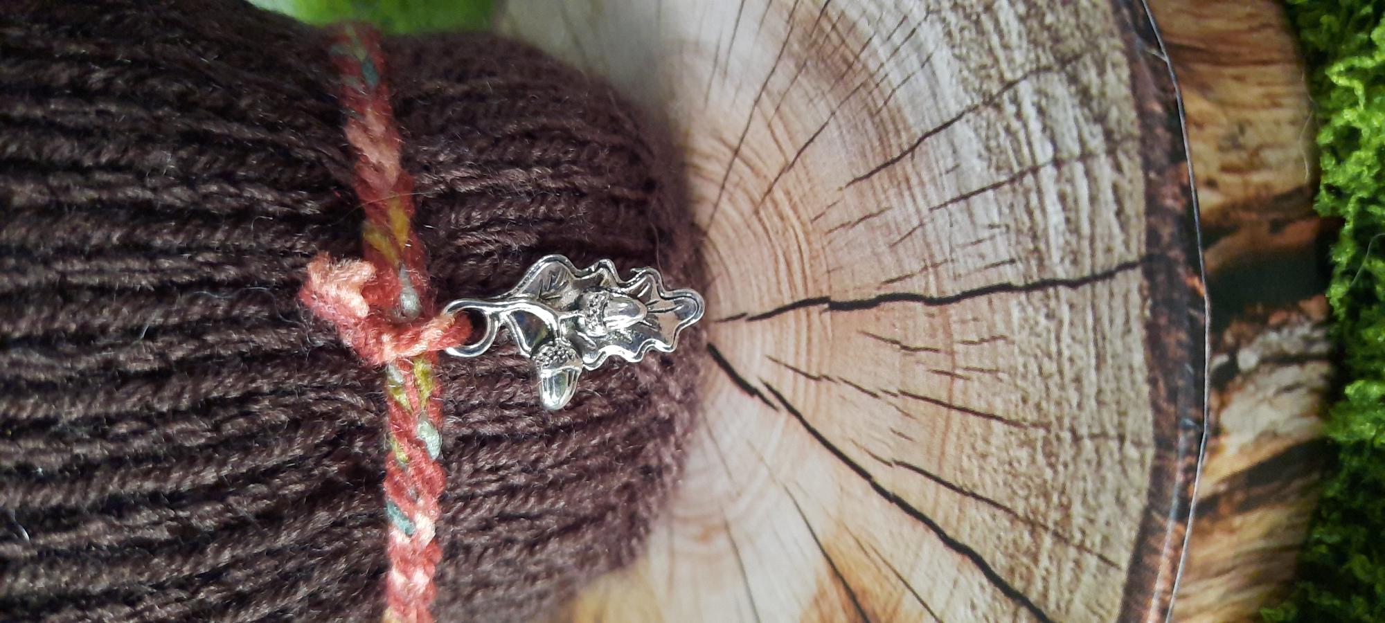 Close-up of Autumn's oak leaf charm