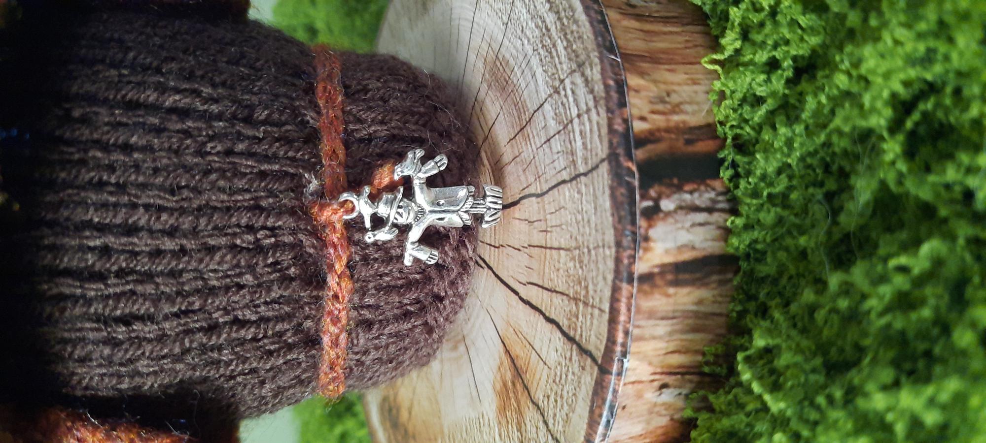 Close-up of Marmalade's scarecrow charm
