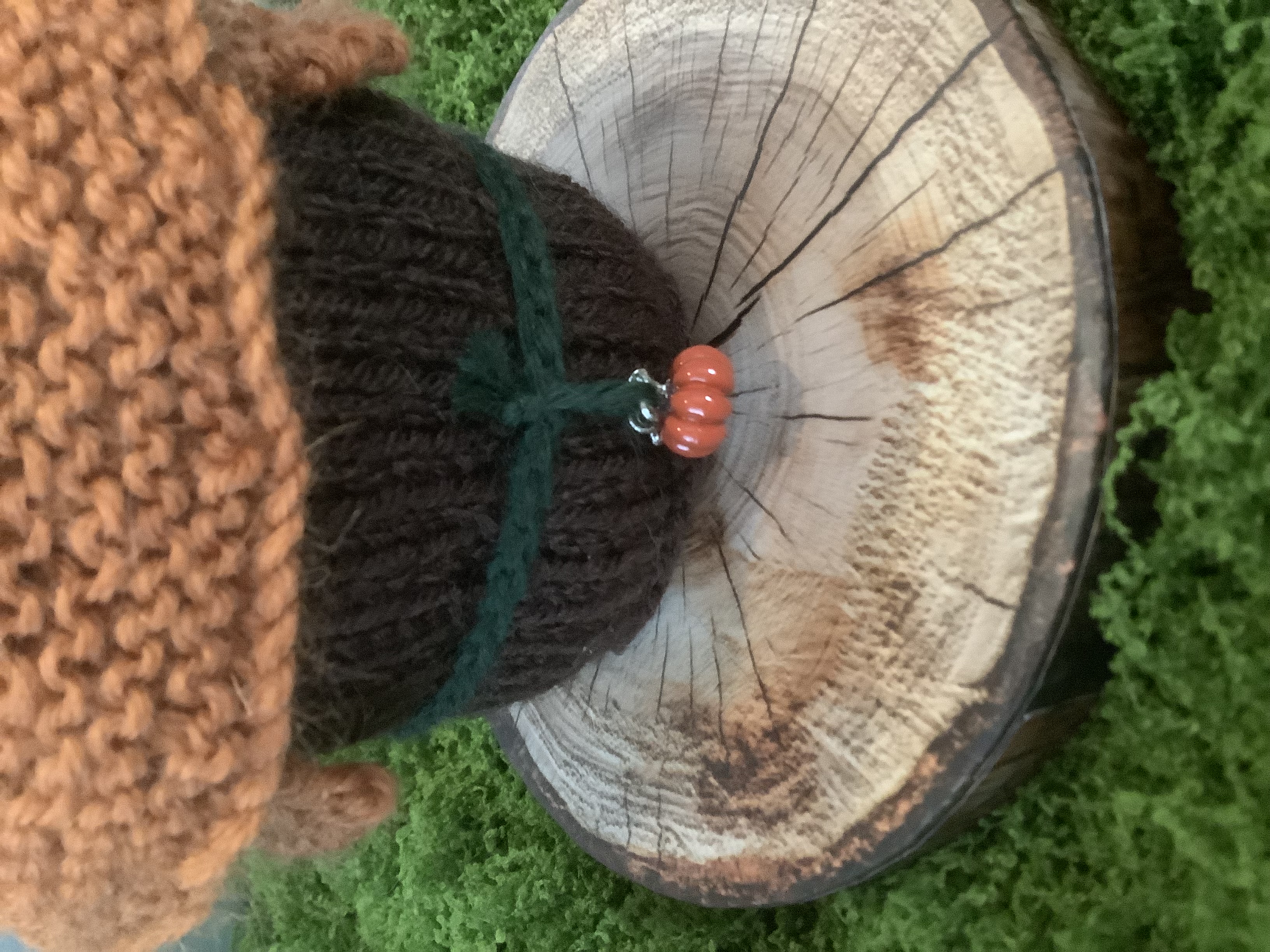 Close-up of Pumpkin's charm and knitted details